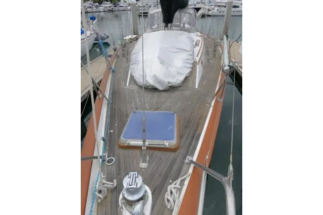 Slide: The Image of 1986 Tayana 52 Center Cockpit sailboat deck with covered equipment, docked in marina. - 61