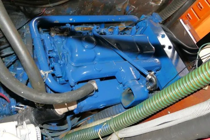 Slide: The Image of Engine compartment of a 1986 Tayana 52 Center Cockpit sailboat, featuring a blue-painted engine. - 67