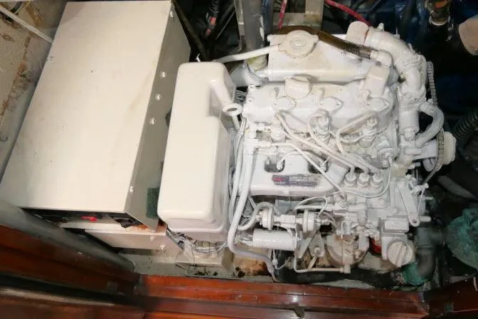 Slide: The Image of Engine compartment of a 1986 Tayana 52 Center Cockpit sailboat, showcasing mechanical components. - 69