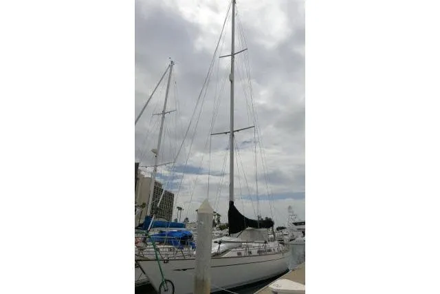 Slide: The Image of 1986 Tayana 52 Center Cockpit sailboat docked under cloudy skies. - 72