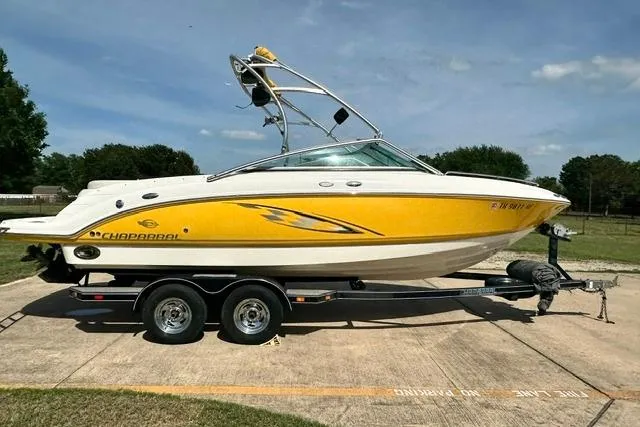 The Image of 2006 Chaparral 236 SSi boat on trailer, yellow and white design, parked outdoors. - 0