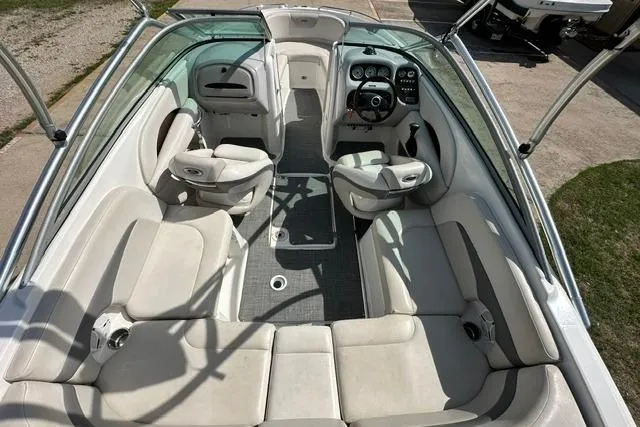 Slide: The Image of 2006 Chaparral 236 SSi boat interior with white seating and steering console. - 10