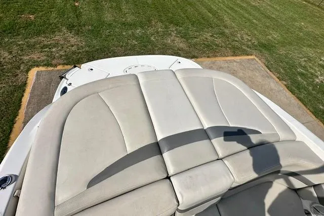 Slide: The Image of 2006 Chaparral 236 SSi boat with beige seating, parked on grass. - 11