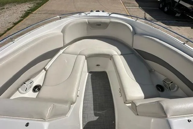 Slide: The Image of 2006 Chaparral 236 SSi boat interior with white cushioned seating and cup holders. - 12