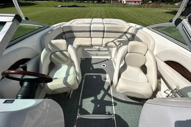 Slide: The Image of Interior of a 2006 Chaparral 236 SSi boat with white seating and steering wheel. - 13
