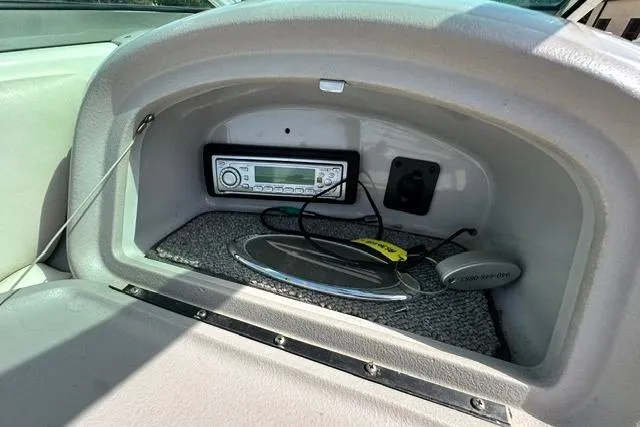 Slide: The Image of 2006 Chaparral 236 SSi boat dashboard with stereo system and storage compartment. - 17