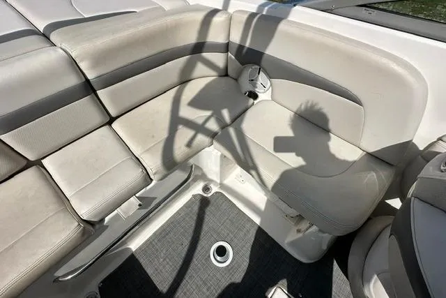 Slide: The Image of Interior seating of 2006 Chaparral 236 SSi boat, featuring beige upholstery and shadow play. - 19