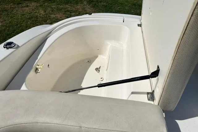 Slide: The Image of 2006 Chaparral 236 SSi boat storage compartment with open lid, showcasing interior space. - 22