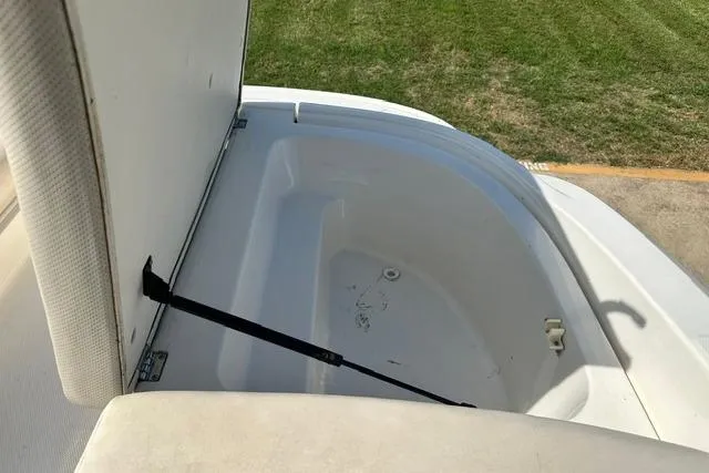 Slide: The Image of Open storage compartment on a 2006 Chaparral 236 SSi boat, showing interior space. - 23