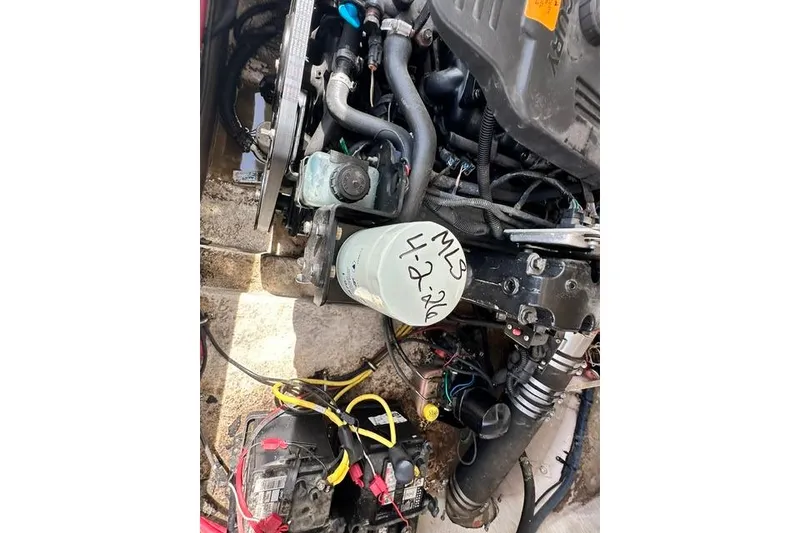 Slide: The Image of Engine compartment of a 2006 Chaparral 236 SSi boat, showing various components and wiring. - 25