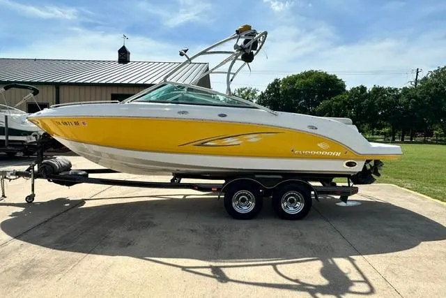 Slide: The Image of 2006 Chaparral 236 SSi boat with yellow and white design on a trailer. - 3
