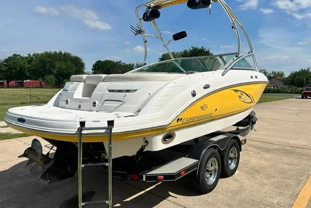 Slide: The Image of 2006 Chaparral 236 SSi boat on trailer, yellow and white design, parked outdoors. - 5