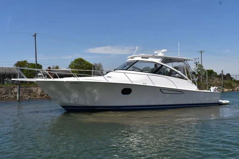 The Image of 2012 Viking 42 Open yacht on calm water under clear blue sky. - 0