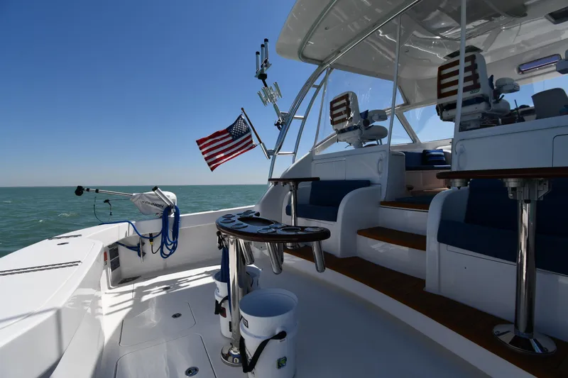 Slide: The Image of 2012 Viking 42 Open yacht deck with seating, American flag, and ocean view. - 10