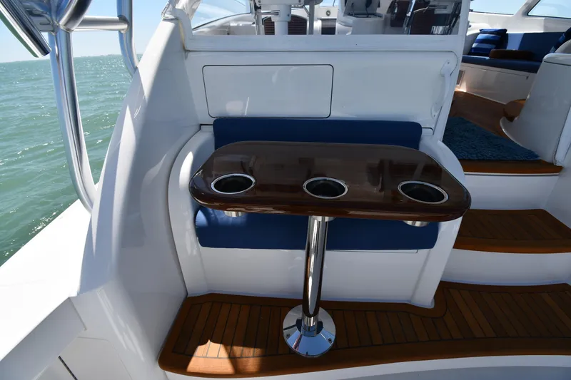 Slide: The Image of 2012 Viking 42 Open yacht interior with wooden table and blue seating. - 12