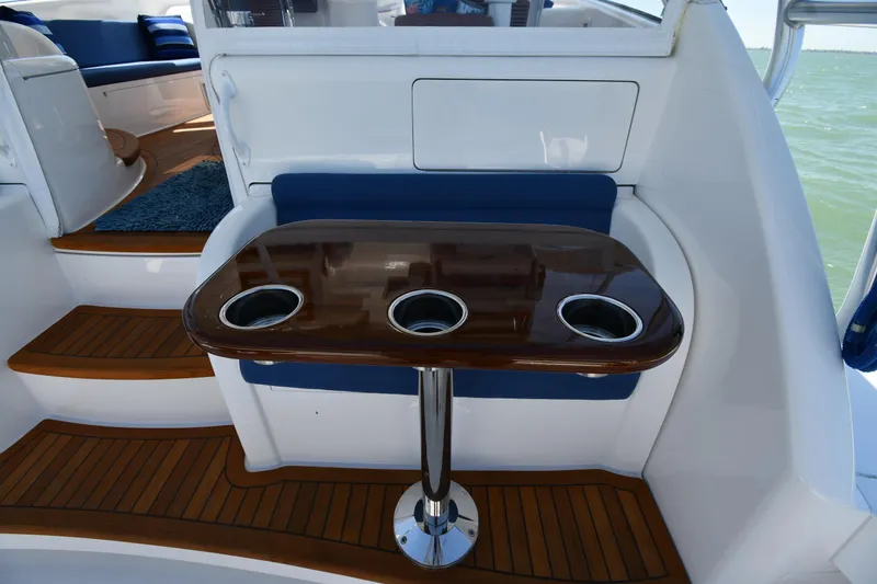 Slide: The Image of Luxurious seating area on 2012 Viking 42 Open yacht with wooden table and cup holders. - 13