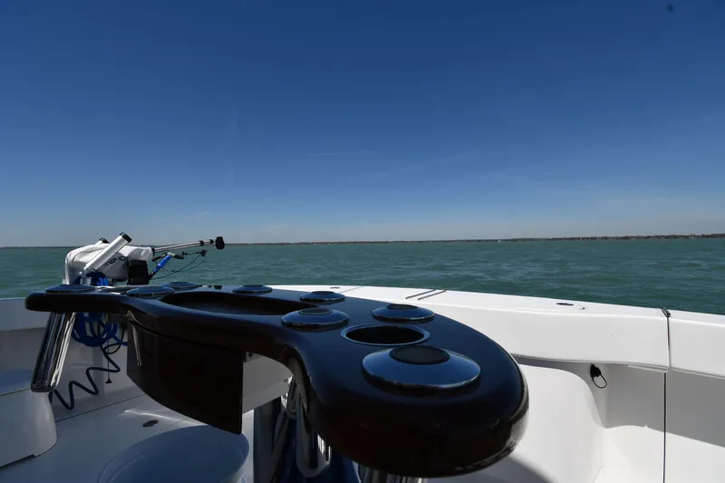 Slide: The Image of 2012 Viking 42 Open boat on calm water under clear blue sky. - 14