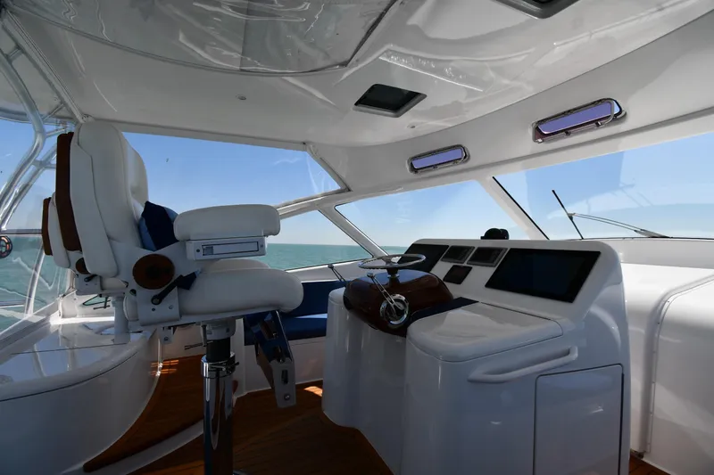 Slide: The Image of Interior of 2012 Viking 42 Open yacht with helm station and seating. - 19