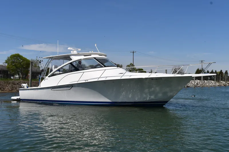 Slide: The Image of 2012 Viking 42 Open yacht on calm water, showcasing sleek design and modern features. - 2