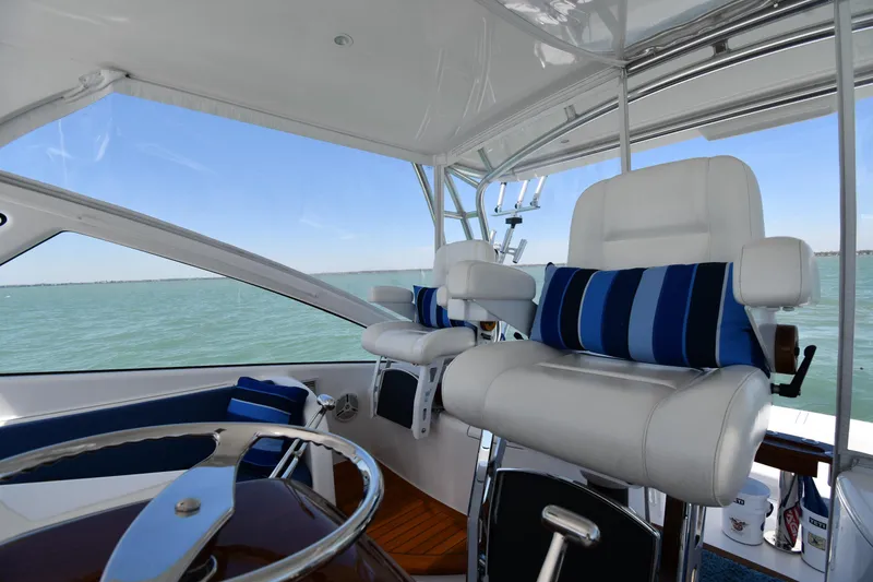 Slide: The Image of Interior of 2012 Viking 42 Open yacht with white seating and ocean view. - 22