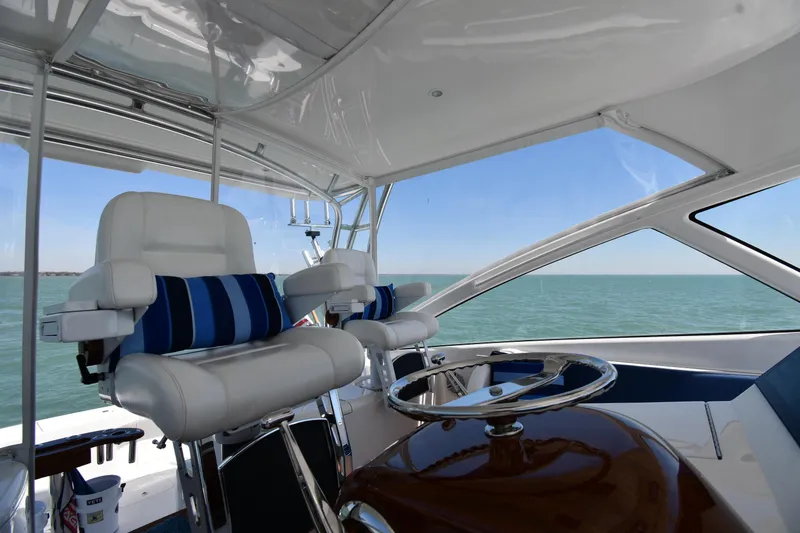 Slide: The Image of Interior view of 2012 Viking 42 Open yacht helm with ocean backdrop. - 23