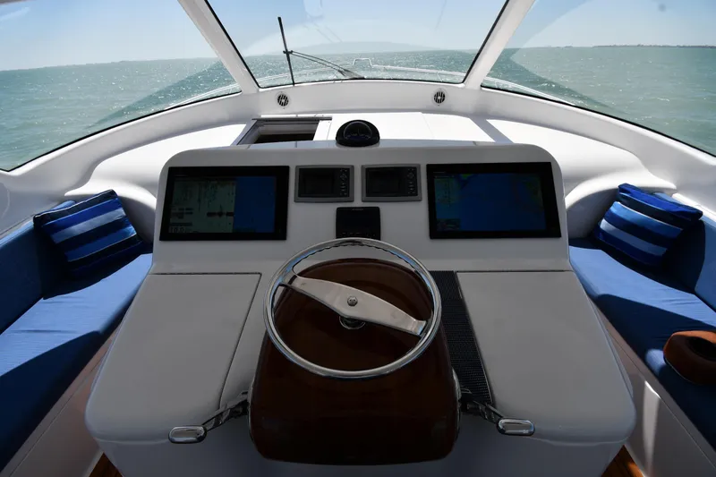 Slide: The Image of Helm of 2012 Viking 42 Open yacht with navigation screens and ocean view. - 24