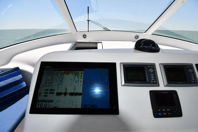Slide: The Image of Helm of 2012 Viking 42 Open yacht with navigation displays and ocean view. - 26