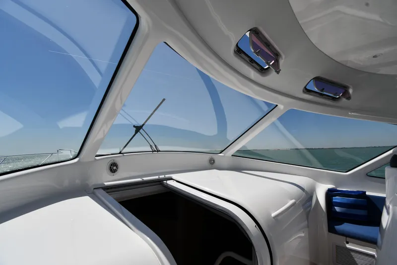 Slide: The Image of Interior view of 2012 Viking 42 Open yacht with panoramic windows and blue seating. - 29