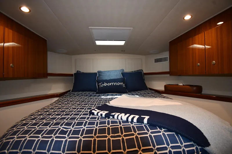 Slide: The Image of Luxurious cabin interior of 2012 Viking 42 Open yacht with elegant bedding and wood cabinetry. - 33