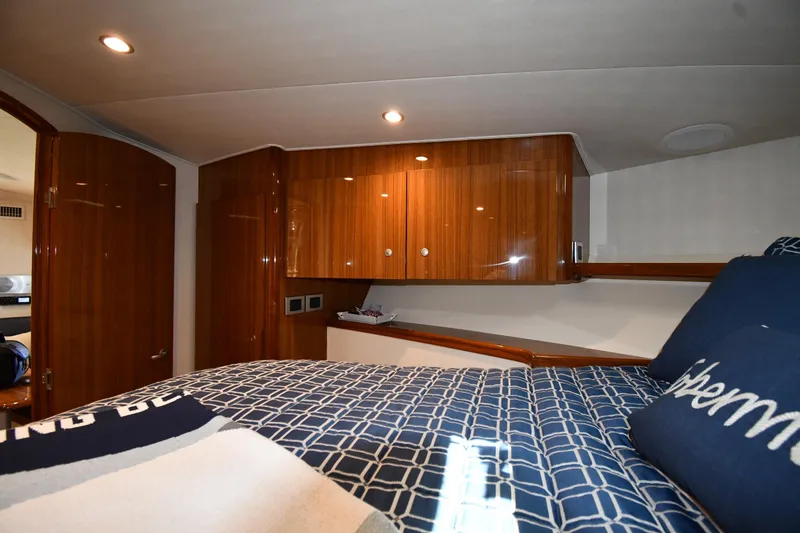 Slide: The Image of Interior of 2012 Viking 42 Open yacht with wooden cabinets and cozy bedding. - 36