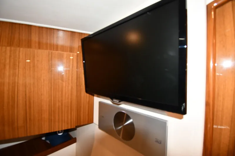 Slide: The Image of Flat-screen TV in 2012 Viking 42 Open yacht interior with wooden paneling. - 38