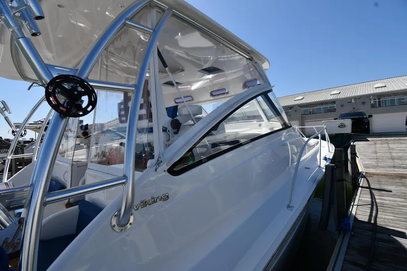 Slide: The Image of 2012 Viking 42 Open yacht docked, showcasing sleek design and modern features. - 4