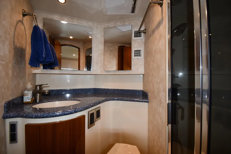 Slide: The Image of Luxurious bathroom interior of 2012 Viking 42 Open yacht with modern fixtures and blue countertop. - 42