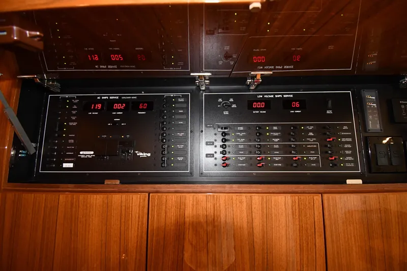Slide: The Image of Electrical control panel inside a 2012 Viking 42 Open yacht, featuring AC and low voltage systems. - 43