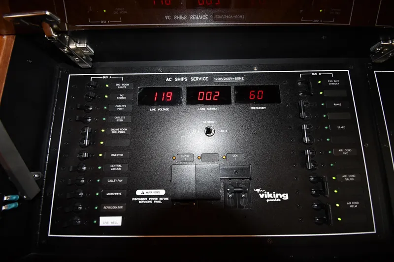 Slide: The Image of Control panel of a 2012 Viking 42 Open yacht, displaying voltage and frequency. - 44