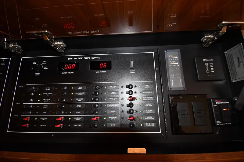 Slide: The Image of Electrical control panel on a 2012 Viking 42 Open yacht, featuring various switches and indicators. - 45