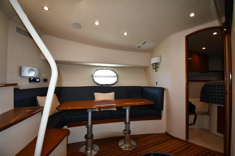 Slide: The Image of Interior of 2012 Viking 42 Open yacht with cozy seating and wooden table. - 47