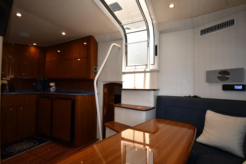 Slide: The Image of Interior of 2012 Viking 42 Open yacht with wooden cabinetry and seating area. - 48