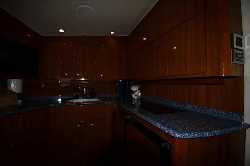 Slide: The Image of Luxurious wooden kitchen interior of 2012 Viking 42 Open yacht with blue countertops. - 49