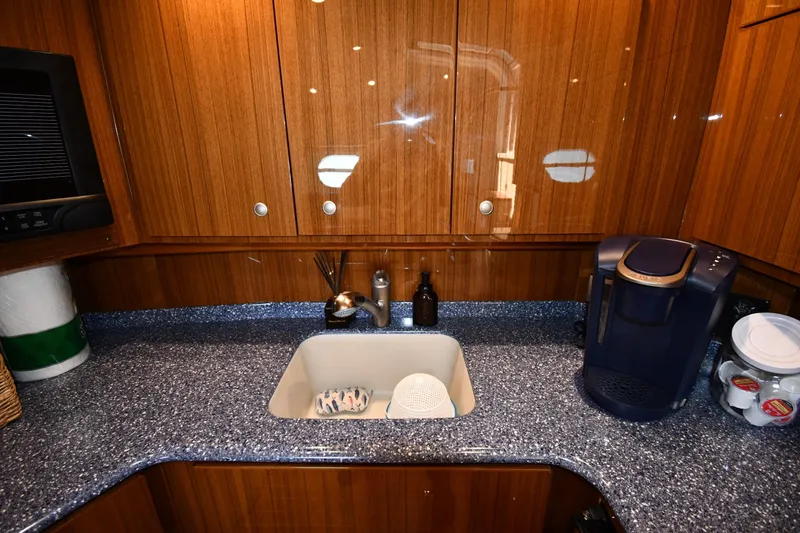 Slide: The Image of Luxurious galley kitchen in 2012 Viking 42 Open yacht with wood cabinetry and modern appliances. - 50