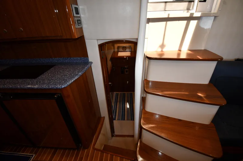 Slide: The Image of Interior of 2012 Viking 42 Open yacht with wooden stairs and countertop. - 55