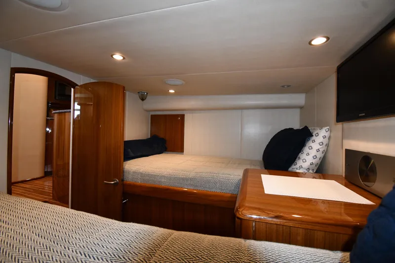 Slide: The Image of Luxurious cabin interior of 2012 Viking 42 Open yacht with cozy bedding and wooden finishes. - 56
