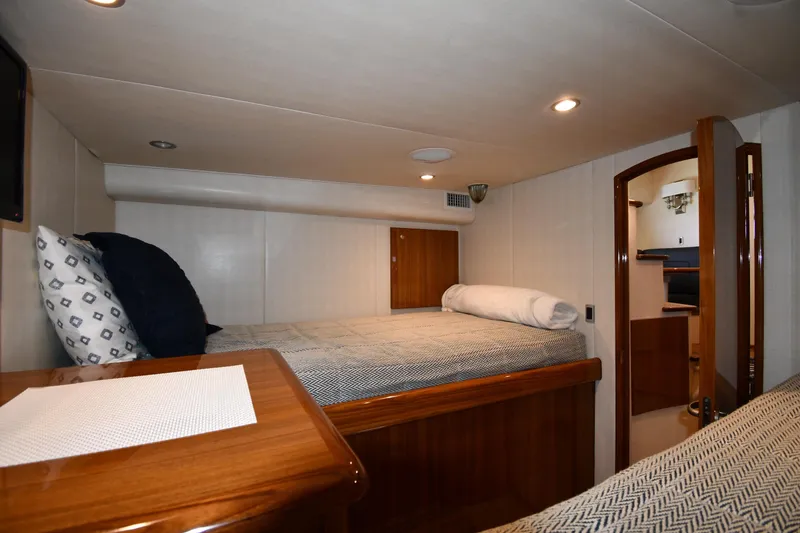Slide: The Image of Interior cabin of 2012 Viking 42 Open yacht with cozy bed and wooden accents. - 57