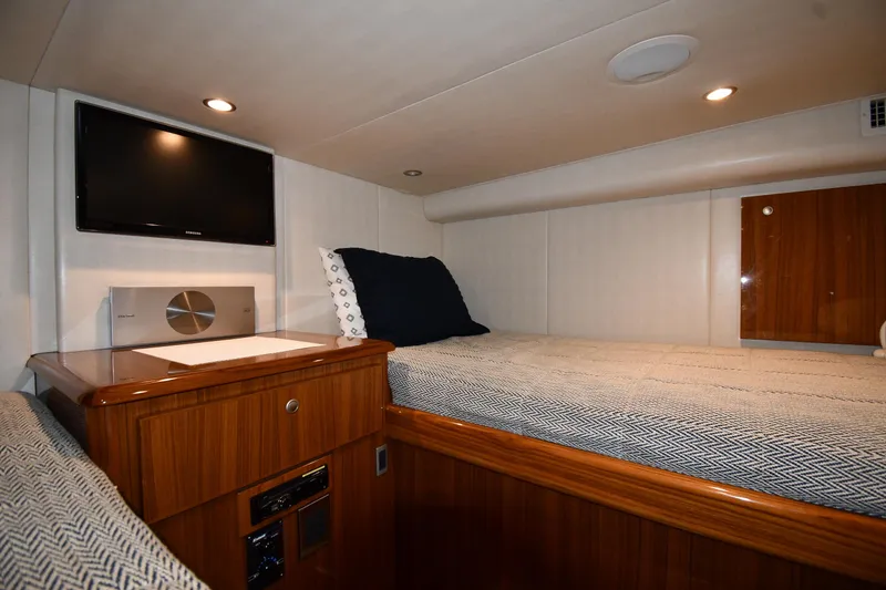 Slide: The Image of Cozy cabin interior of 2012 Viking 42 Open yacht with bed and TV. - 58