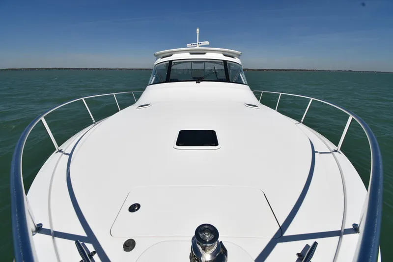 Slide: The Image of 2012 Viking 42 Open yacht on calm waters under clear blue sky. - 6