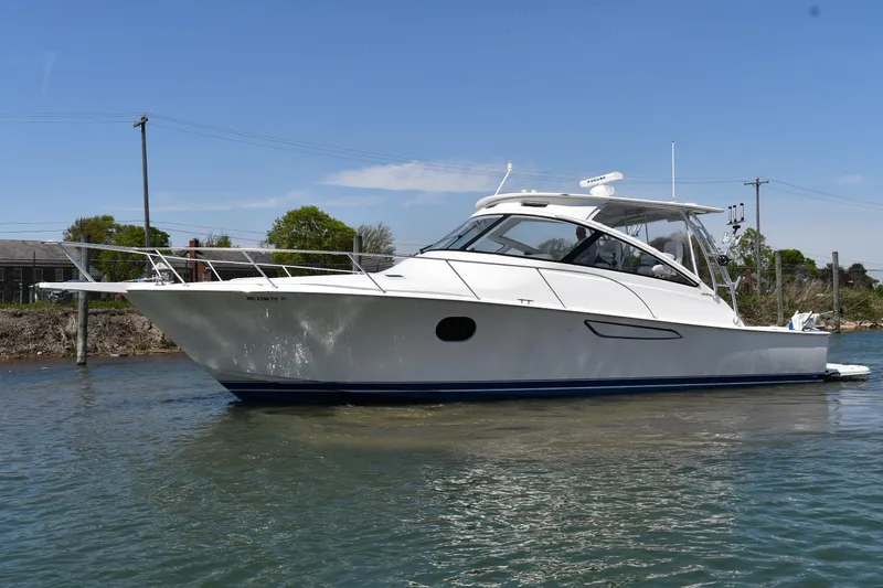 Slide: The Image of 2012 Viking 42 Open yacht on calm water under clear blue sky. - 63