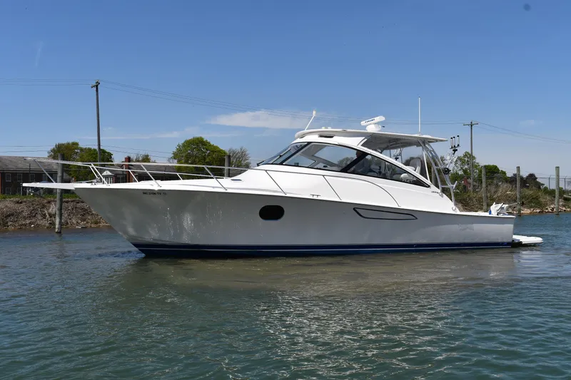 Slide: The Image of 2012 Viking 42 Open yacht on calm water, showcasing sleek design and modern features. - 64