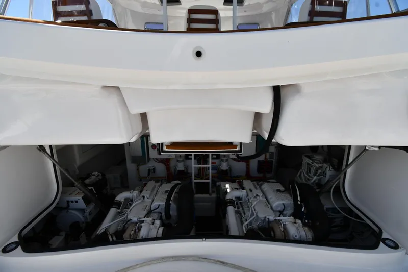 Slide: The Image of Engine compartment of a 2012 Viking 42 Open yacht, showcasing dual engines and mechanical systems. - 65