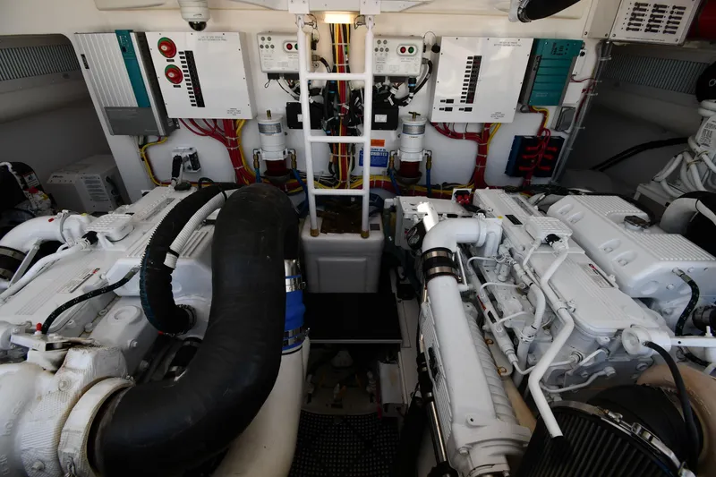 Slide: The Image of Engine room of a 2012 Viking 42 Open yacht, showcasing dual engines and control systems. - 66