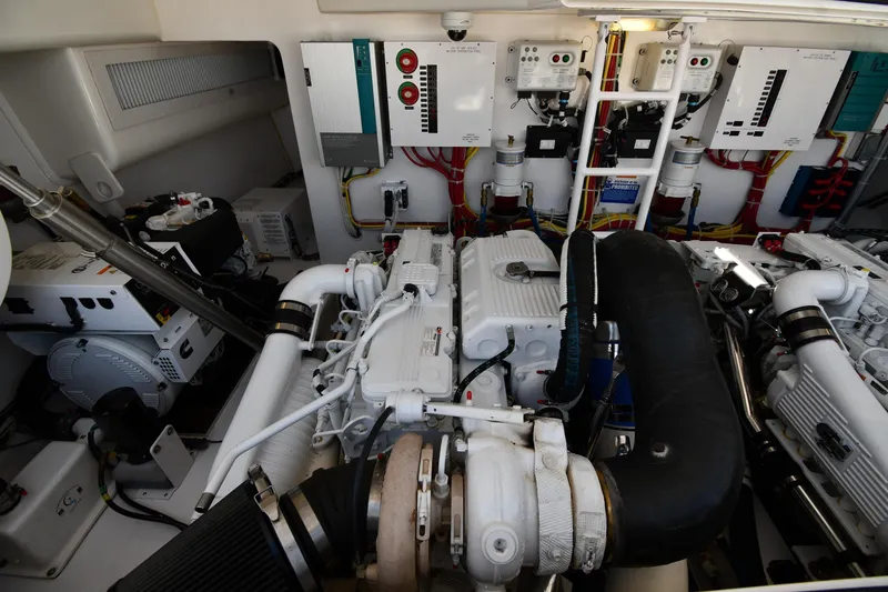 Slide: The Image of Engine room of a 2012 Viking 42 Open yacht, showcasing complex machinery and wiring. - 67